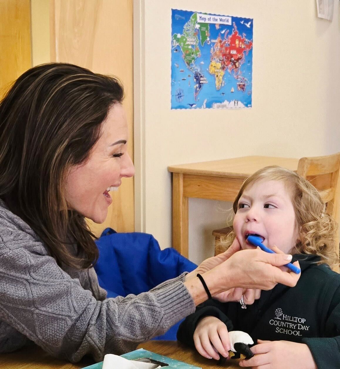 Kaycee working one-on-one with a child during a speech therapy session